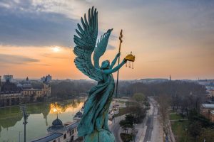 Budapest, Hungary - Aerial view of Gabriel Archangel at Heroes' Square during the 2020 Coronavirus quarantine in the morning. Vajdahunyad Castle and City Park at background with a warm sunrise